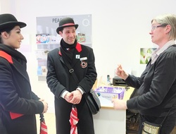 Two tour guides talking to a woman