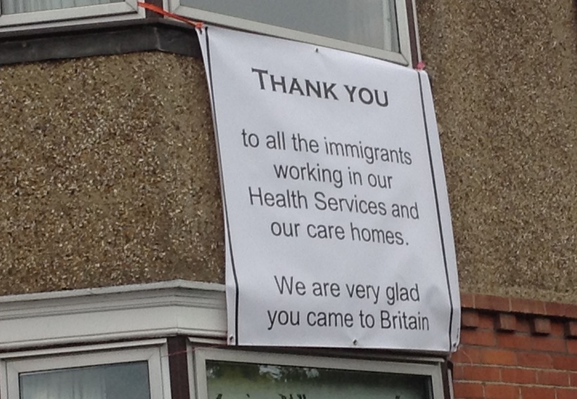 Banner saying thank you to all the immigrants working in our health services and our care homes. We are very glad you came to Britain.