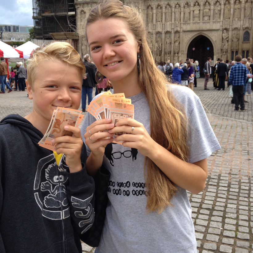 Young people holding Exeter pound notes at the launch