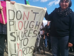 Anna Botwright and a Friend hold a "Don't plough shares into swords" banner at the stop the Arms Fair Demonstration.