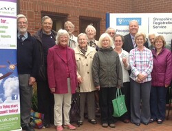 Group of Quakers stood outsied locak credit union building