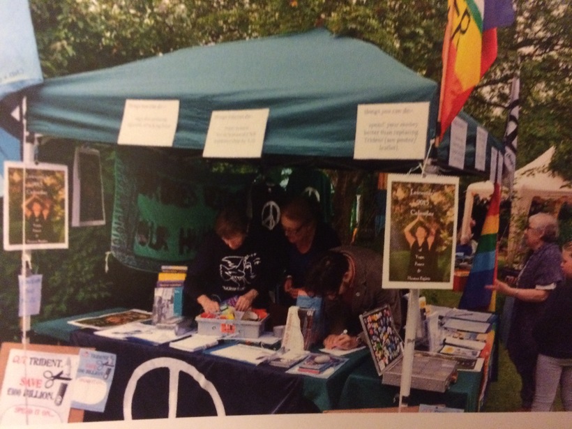 two people in a stall with peace banners