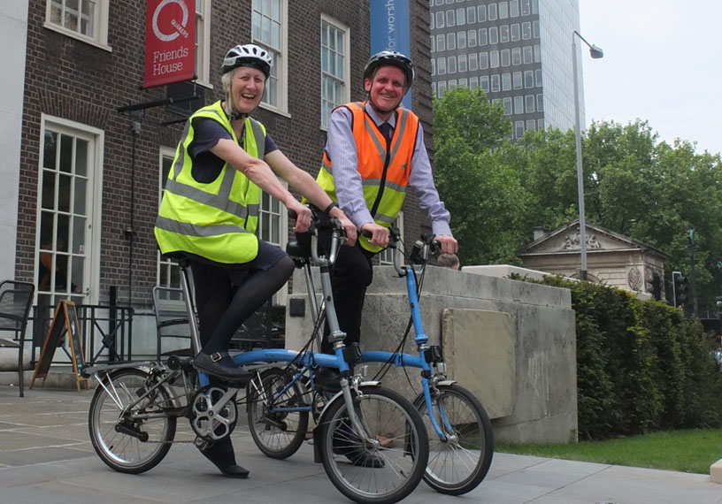 Smiling man and woman on bicycles