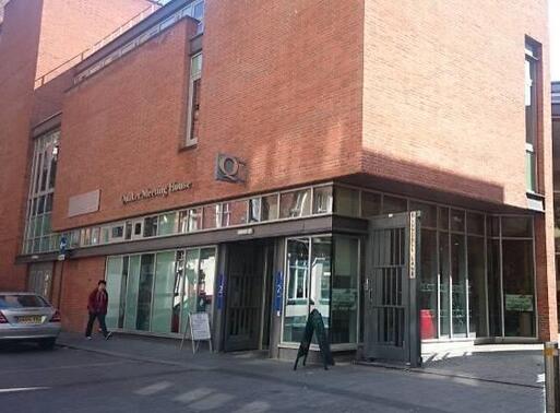 Modern and representative red building with visible sign 'Quakers Meeting House'.