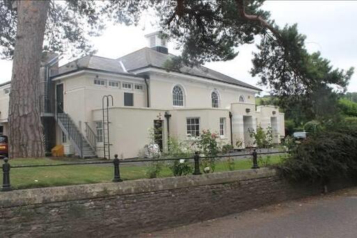 Complex of buildings. The main building is rectangular on plan with roughcast walls.