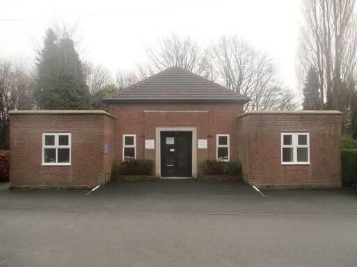 Building of simplicity and modest design with a gently sloping ramp to provide access into the building.