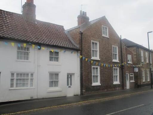 Purpose built brick two-storey meeting house with a back garden.