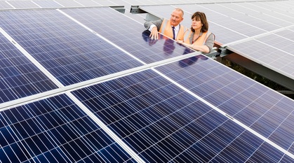 The UK minister for climate change surveys a solar panel