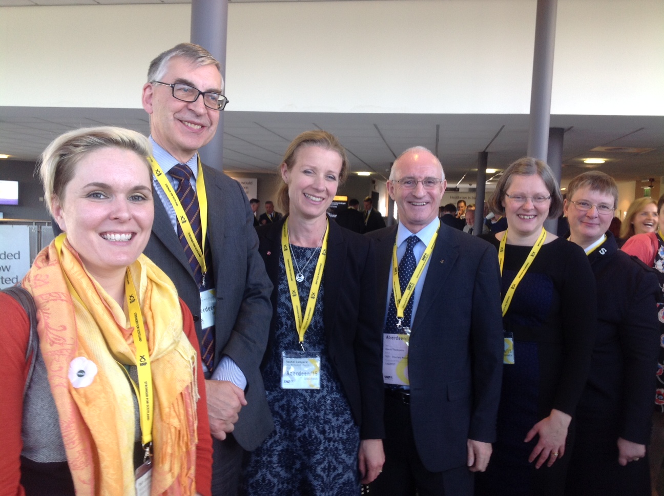 5 people posing for the camera with SNP lanyards around their necks