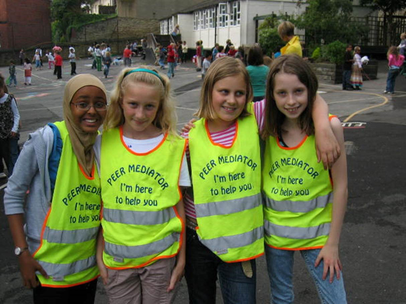 4 mediator girls in busy playground