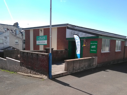 Red brick, flat roofed building with green sign saying 'Art Society'