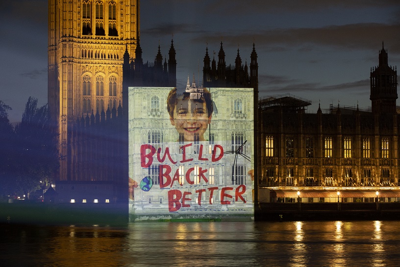 child holds placard says to PM build Back Better