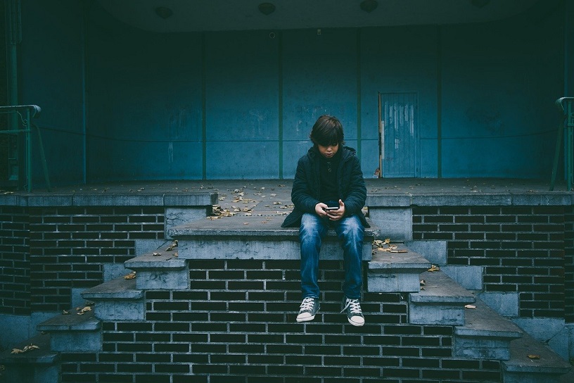 young boy alone on staircase