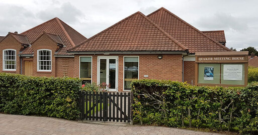 Red brick, single-storey, building with red tiled roof.