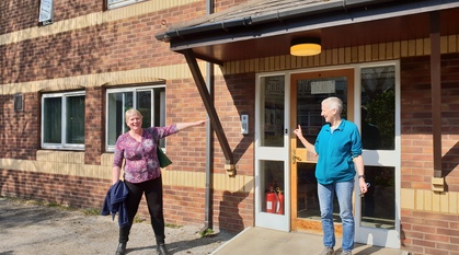 Two people standing outside and office