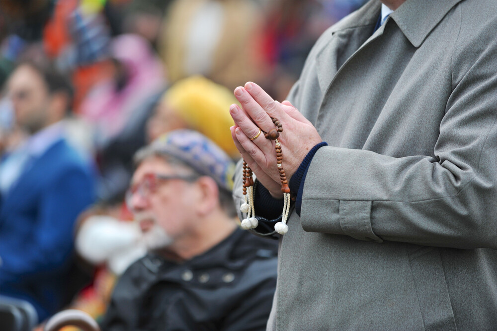 Hands holding prayer beads