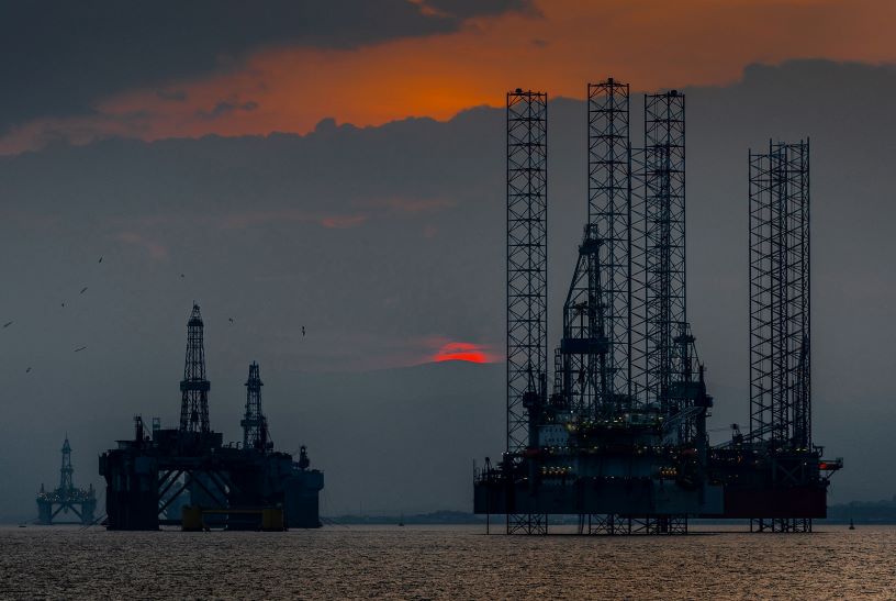 Old oilrigs against sunset