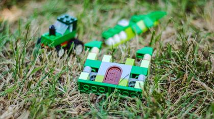 Lego toys laying in grass