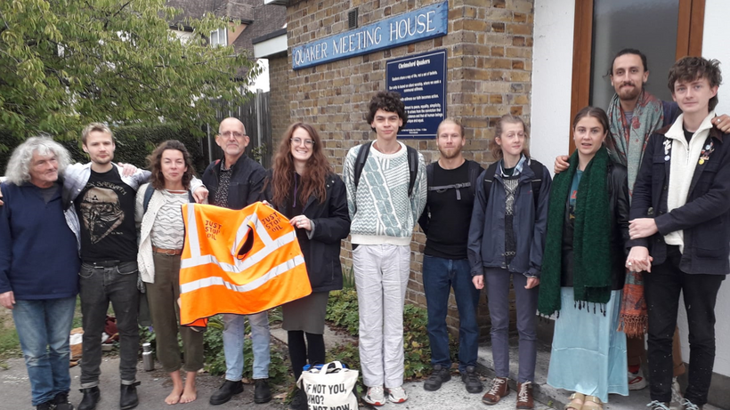 A group of people standing outside a meeting house