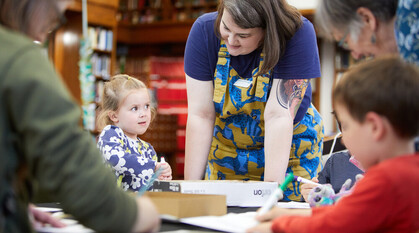 Children doing an activity at a table supported by adults