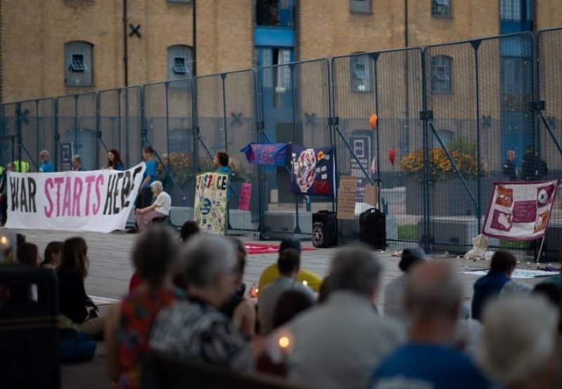 People holding candles and banners