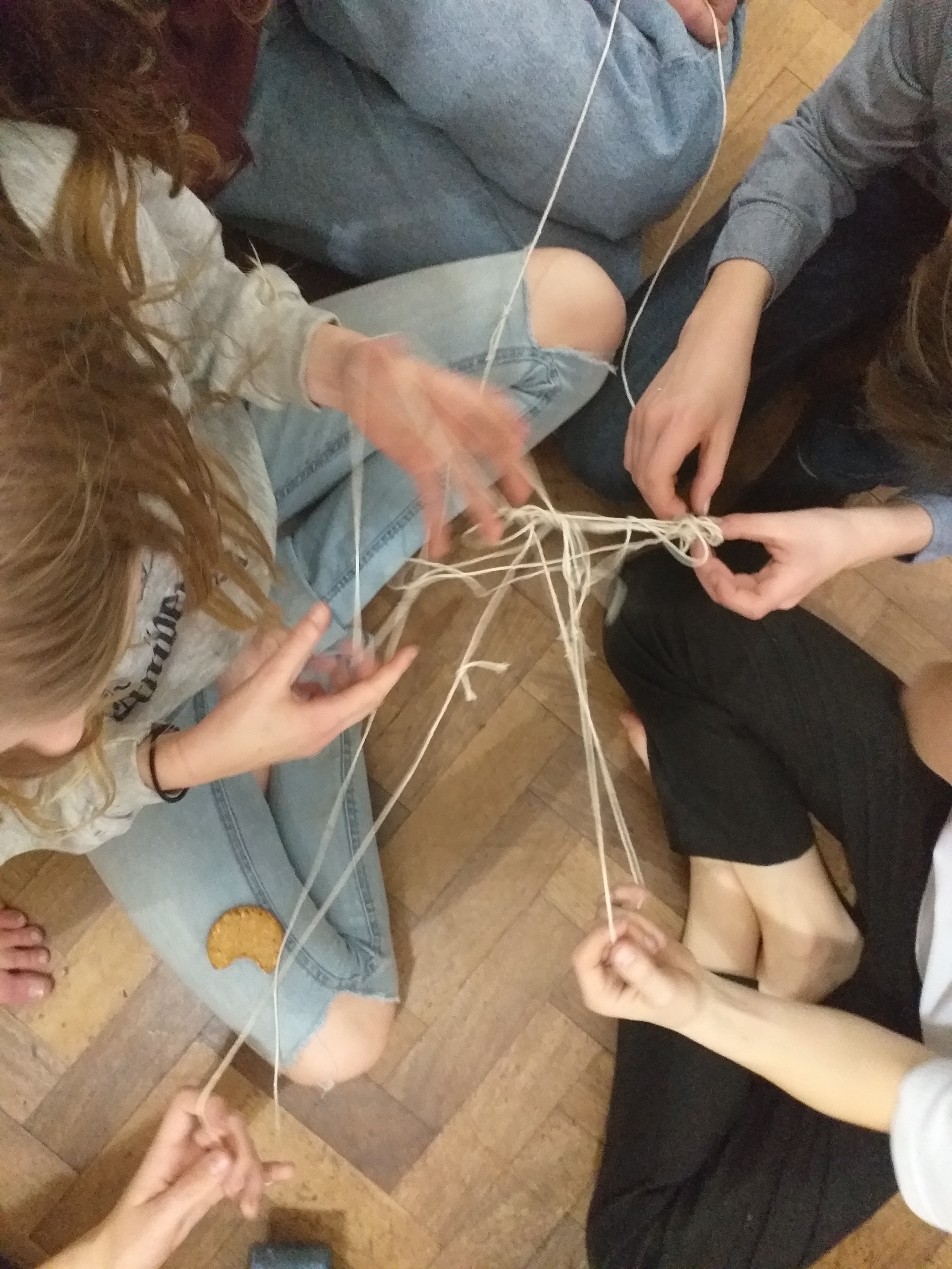 Hands holding a network of string