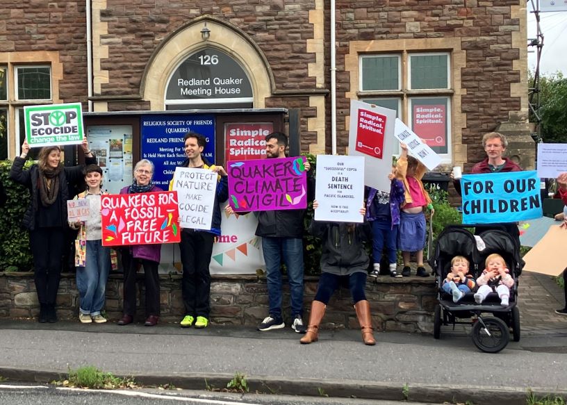 people with banners in front of a meeting house