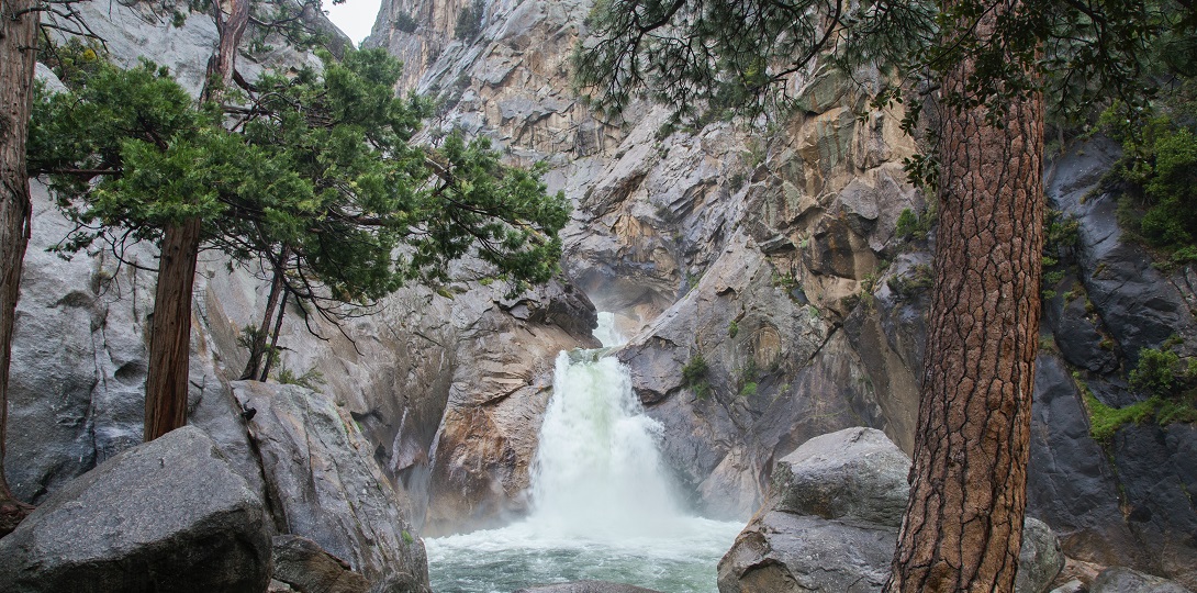 A rocky valley with a waterfall