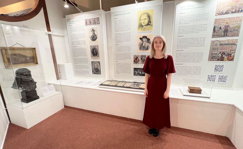 woman in front of display case