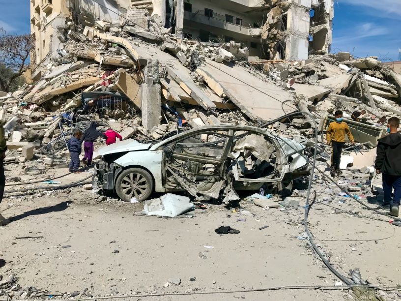 Bombed out buildings and a wrecked car