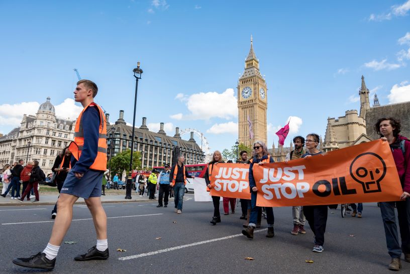 Protestors holding Just Stop Oil orange banners