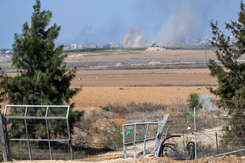 Smoke in the distance with dry fields in foreground