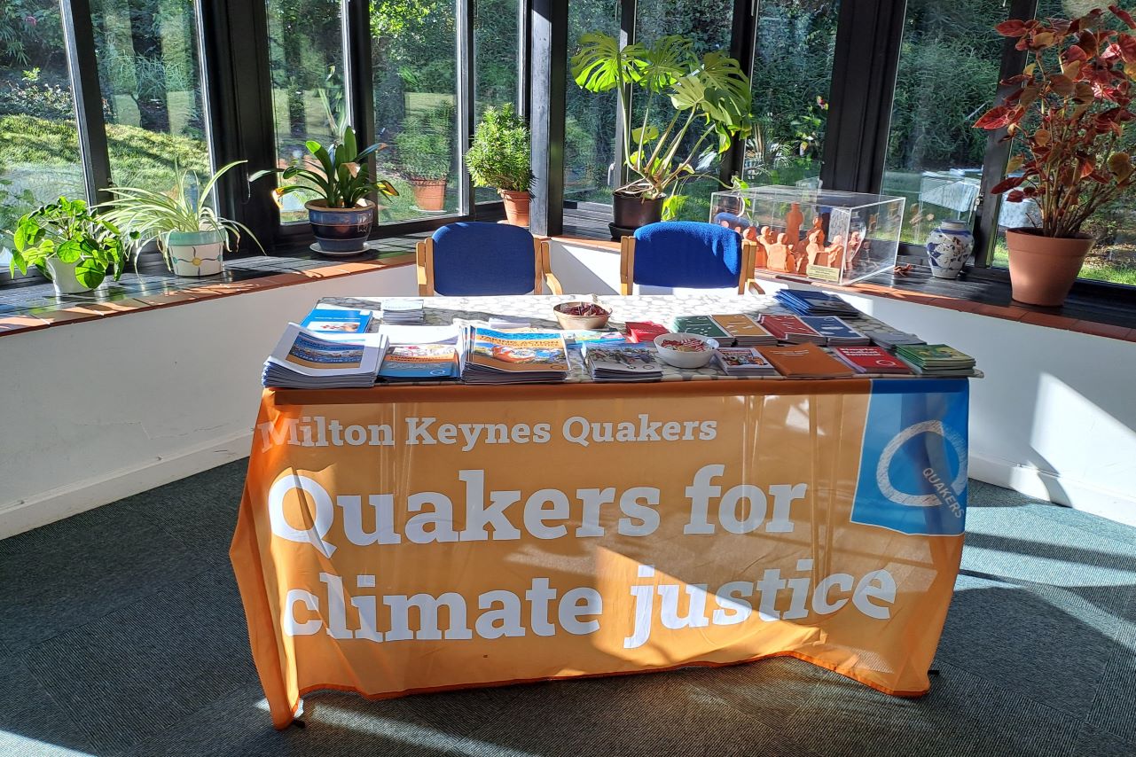 Table set up with orange banner and leaflets