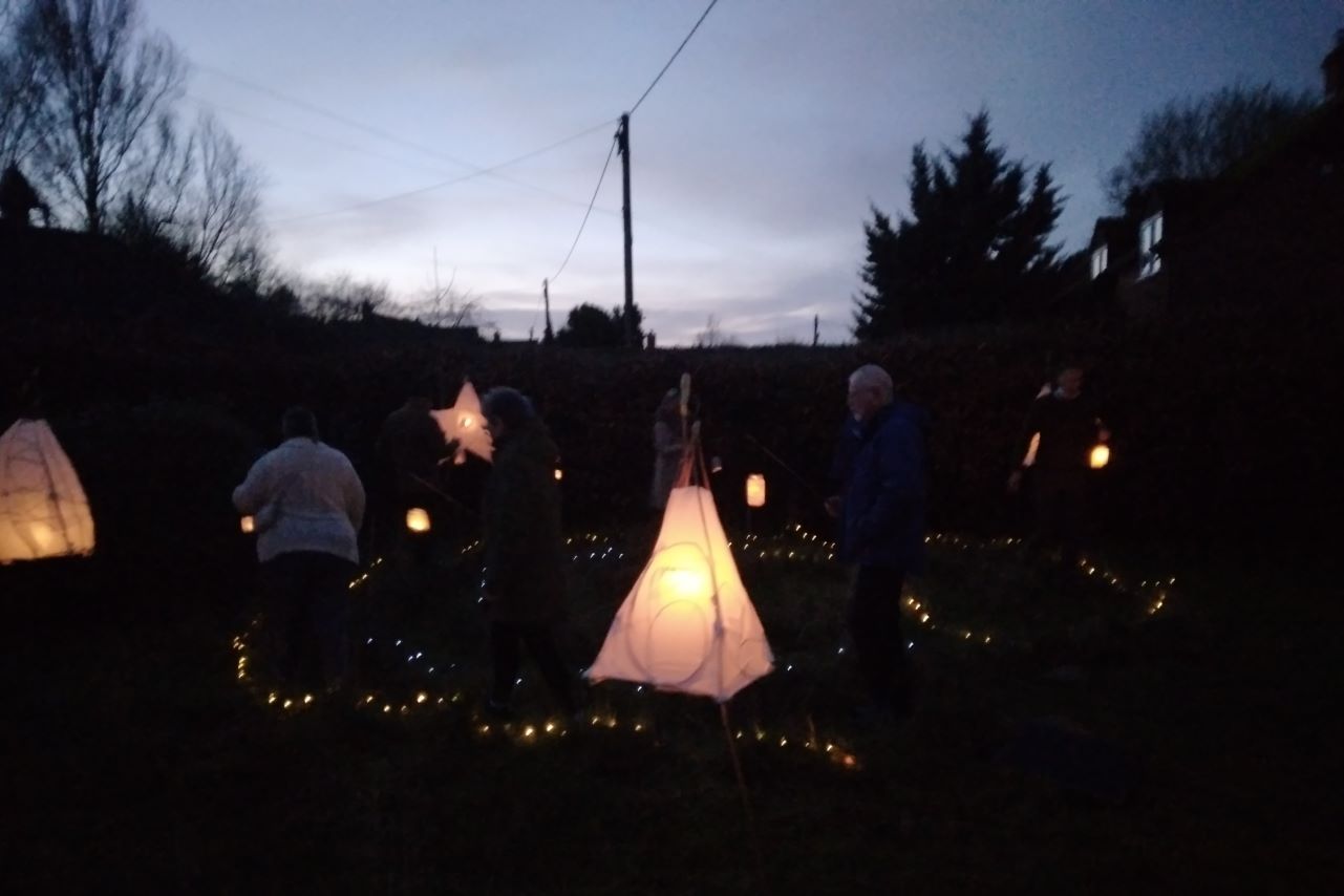 candles and lanterns in darkening sky