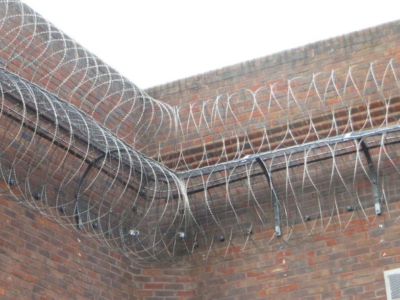 brick wall and razor wire