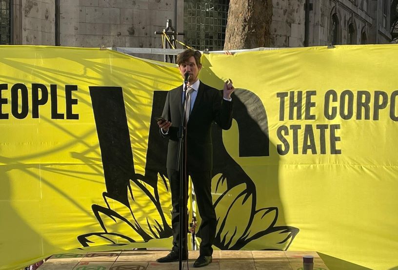 Man standing against yellow banner