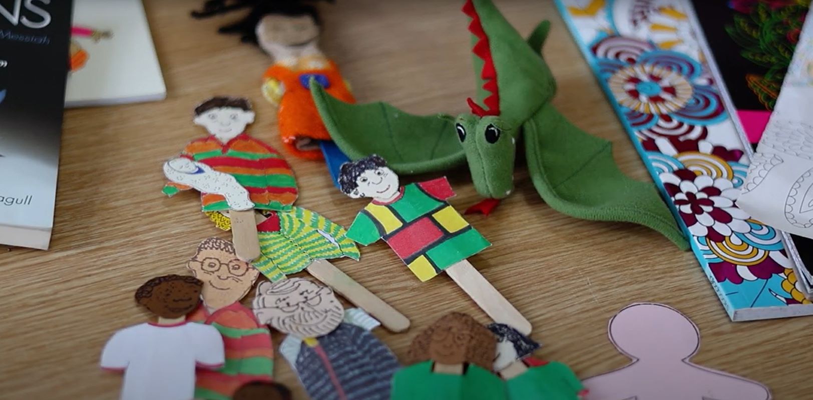 stick puppets and green dragon toy