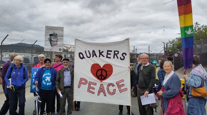 Protesters gather round a Quaker peace banner in front of Faslane navy base