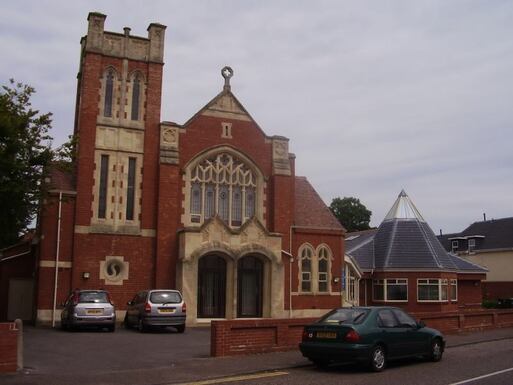 Red brick church with ornate window surrounds