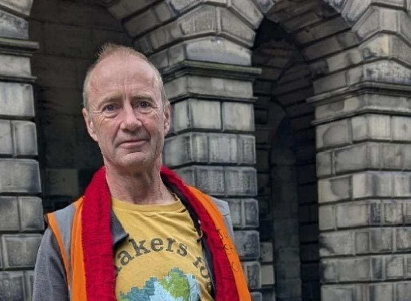 Man in yellow Quaker tshirt