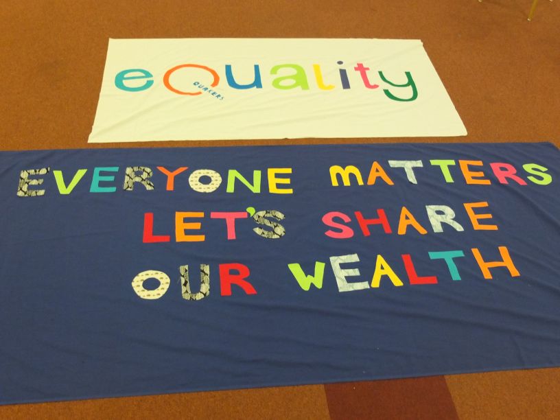 Banners reading Equality and Everyone matters, let's share our wealth