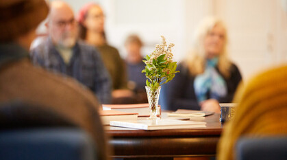 A group of people sat quietly in a meeting for worship