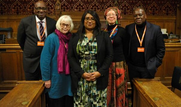 Panel and audience in front of slide reading Don't be silenced