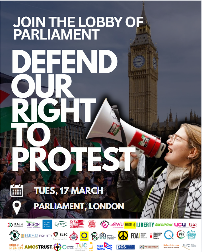Person speaking into loudhailer outside parliament with words 'Defend our right to protest' alongside