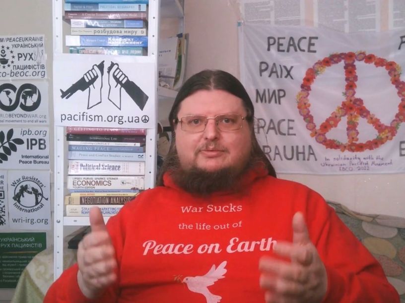Bearded man in red sweatshirt with peace slogans