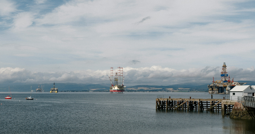 In the midst of a climate emergency we need to speed up our transition away from fossil fuels. Photo: Oil rigs in Cromarty Firth by <a href="https://unsplash.com/@blinky264?utm_source=unsplash&utm_medium=referral&utm_content=creditCopyText">Marc Pell</a> on <a href="https://unsplash.com/photos/sailboats-and-a-pier-on-a-calm-sea-P-W94svJNLc?utm_source=unsplash&utm_medium=referral&utm_content=creditCopyText">Unsplash</a>.