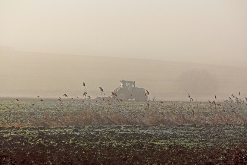 The brutal blows of climate chaos don’t fall equally upon us all. As the world burns, the gap between rich and poor widens. Photo by <a href="https://unsplash.com/@rickyrew?utm_source=unsplash&utm_medium=referral&utm_content=creditCopyText">Ricky Rew</a> on <a href="https://unsplash.com/photos/a-tractor-in-a-foggy-field-with-a-flock-of-birds-ZqFCWat0Mgw?utm_source=unsplash&utm_medium=referral&utm_content=creditCopyText">Unsplash</a>