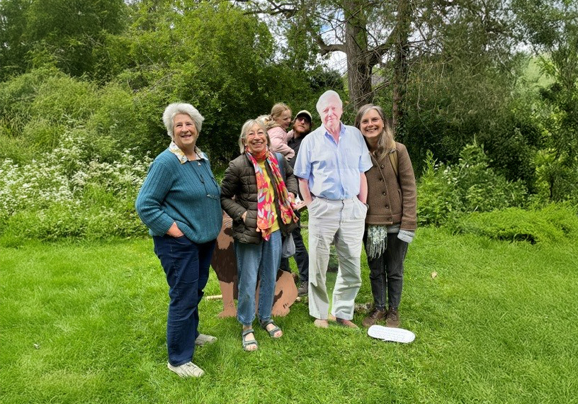 People posing with a cut out of David Attenborough