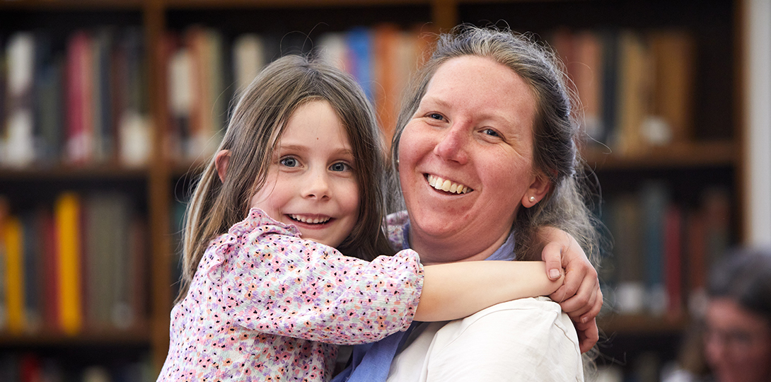 Woman holding child in library