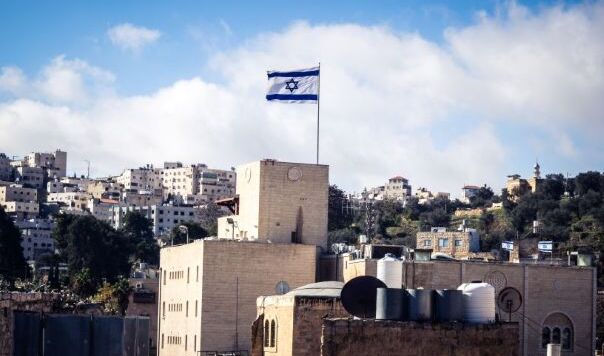 Israel's flag flying over cityscape